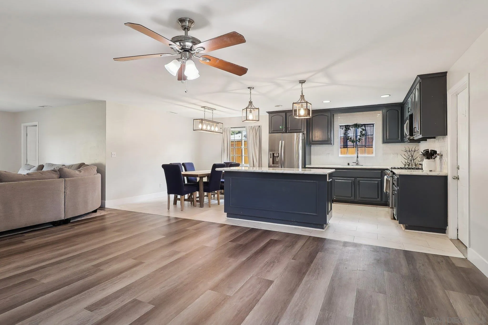 1673 Walbollen Street Spring Valley, CA 91977 - Photo 6 of 21 a living room with stainless steel appliances kitchen island granite countertop furniture and a kitchen view