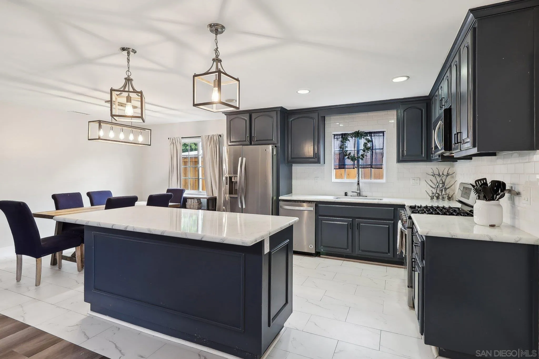 1673 Walbollen Street Spring Valley, CA 91977 - Photo 8 of 21 a large kitchen with a counter space a sink appliances and cabinets