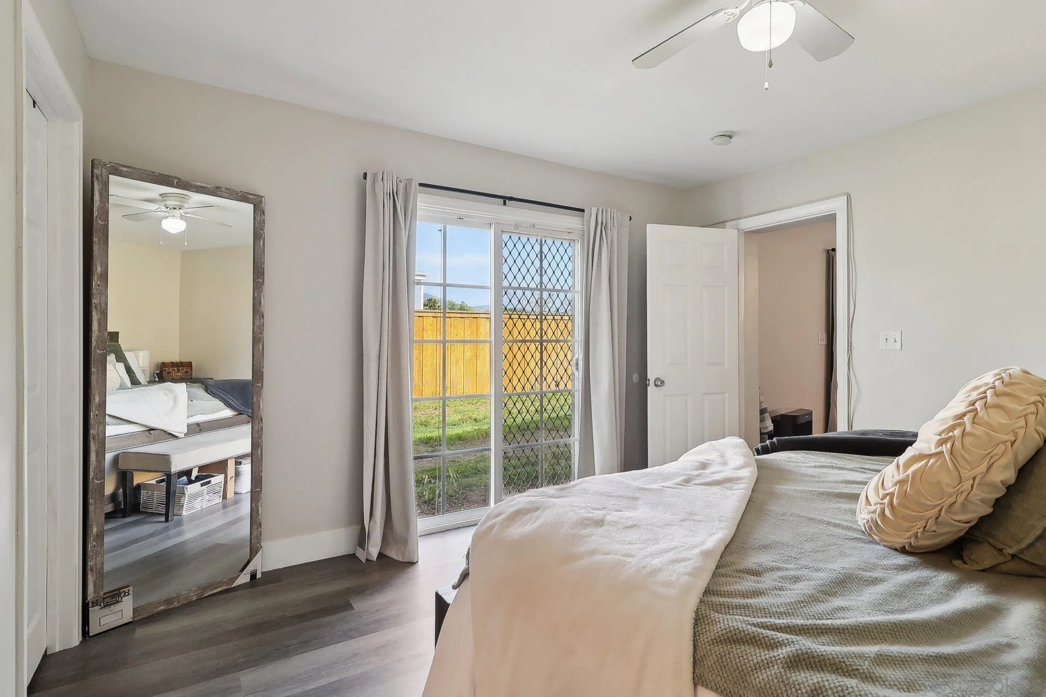 1673 Walbollen Street Spring Valley, CA 91977 - Photo 10 of 21 a bedroom with a bed and a chandelier