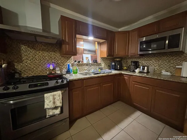 a kitchen with a sink stove and microwave