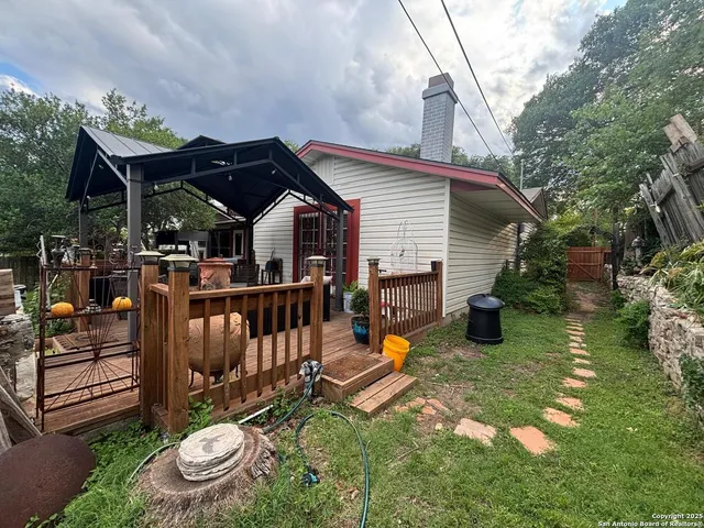 a view of a chair and table in backyard