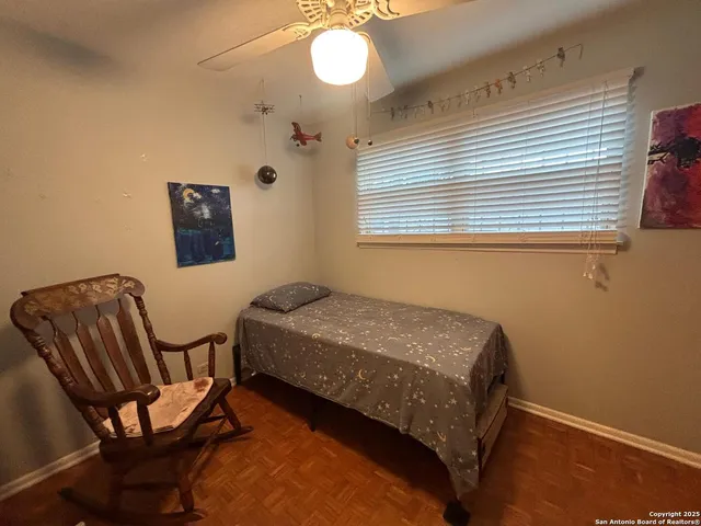 a bedroom with a bed chair and window