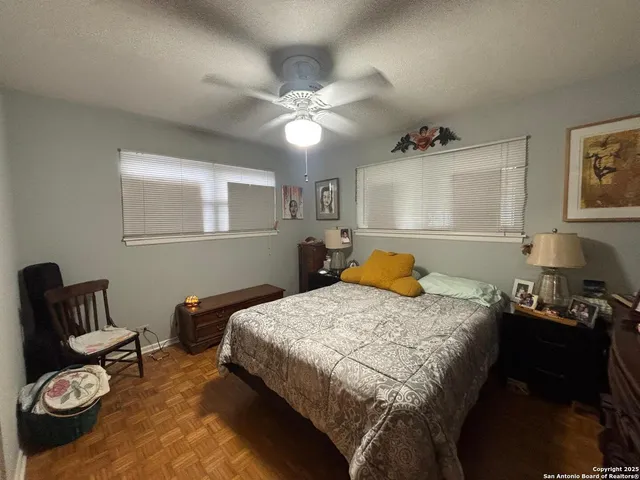 a bedroom that has a bed and a chandelier