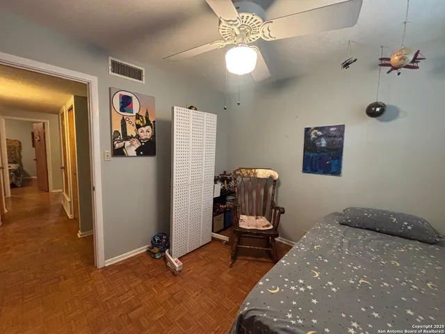 a room with gym equipment and a chandelier