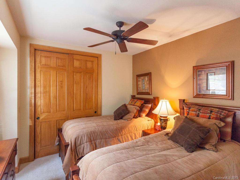 755 Andrew Banks Road Burnsville, NC 28714 - Photo 12 of 24 a bedroom with two beds and painting on the wall