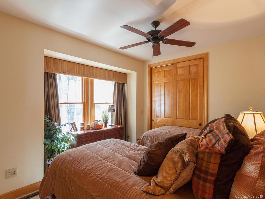 755 Andrew Banks Road Burnsville, NC 28714 - Photo 13 of 24 a bedroom with a large bed and a window