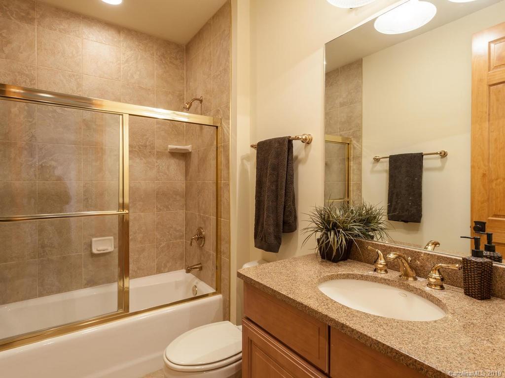 755 Andrew Banks Road Burnsville, NC 28714 - Photo 14 of 24 a bathroom with a granite countertop sink toilet and shower