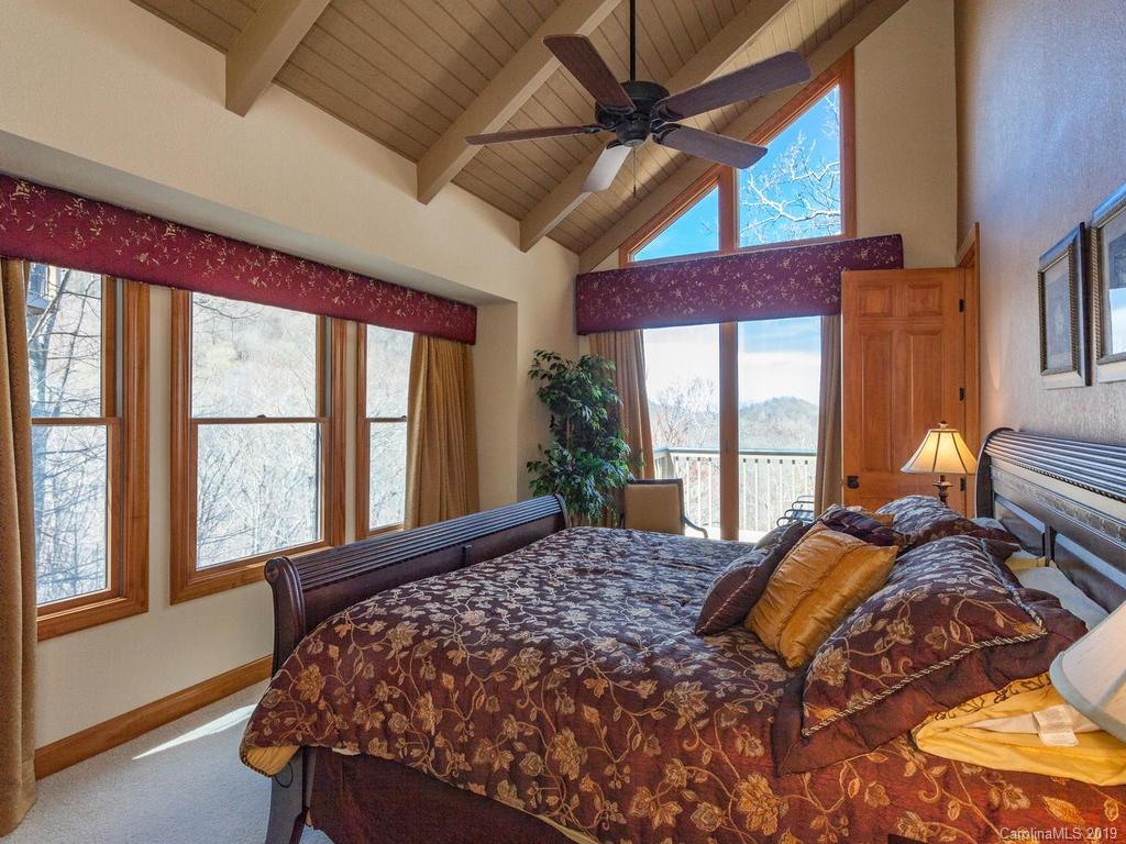 755 Andrew Banks Road Burnsville, NC 28714 - Photo 15 of 24 a bed sitting in a bedroom next to a window