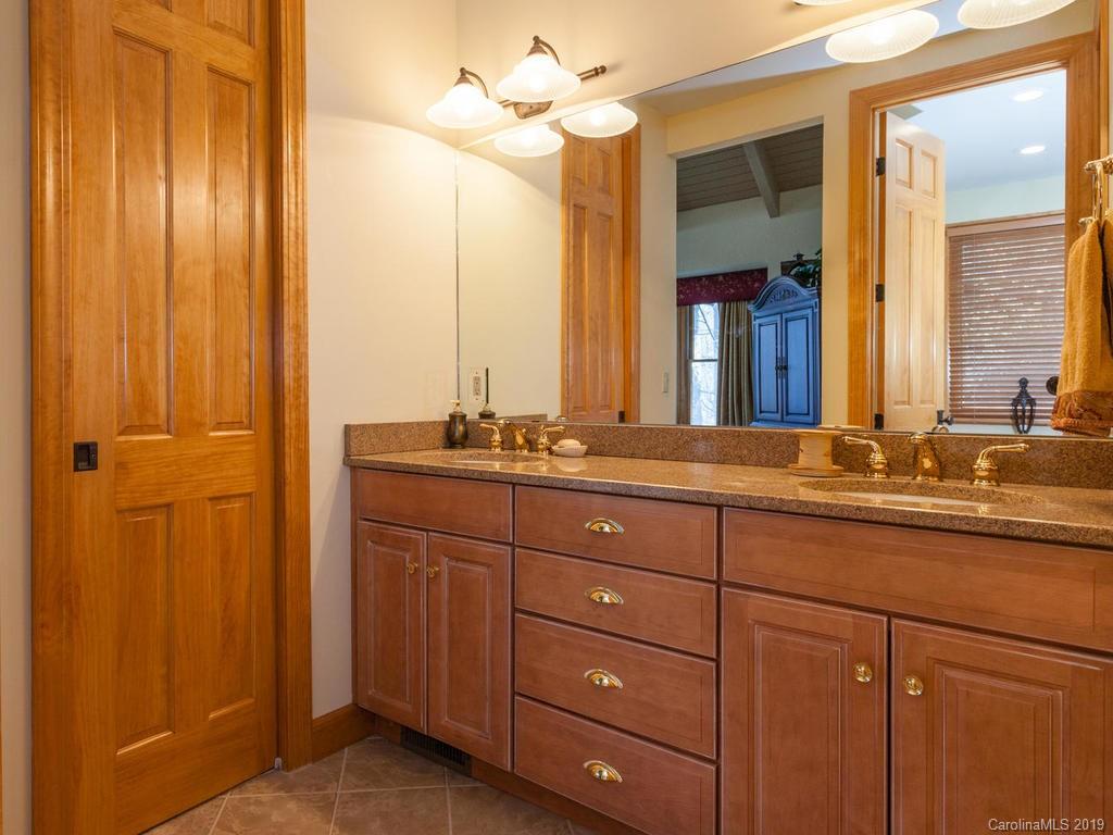 755 Andrew Banks Road Burnsville, NC 28714 - Photo 17 of 24 a bathroom with a granite countertop sink and a mirror