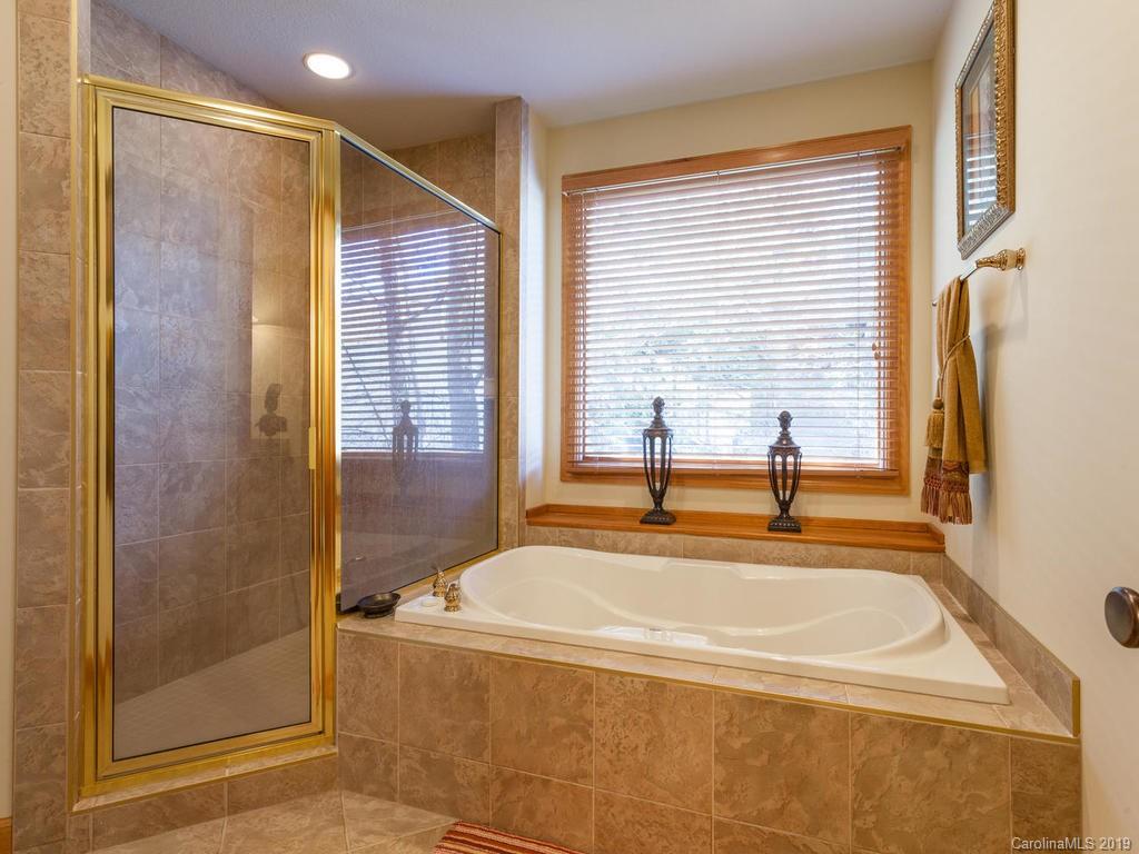 755 Andrew Banks Road Burnsville, NC 28714 - Photo 18 of 24 a bathroom with a tub and a shower