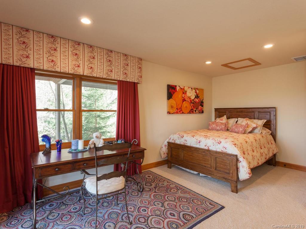 755 Andrew Banks Road Burnsville, NC 28714 - Photo 22 of 24 a bedroom with furniture and a window