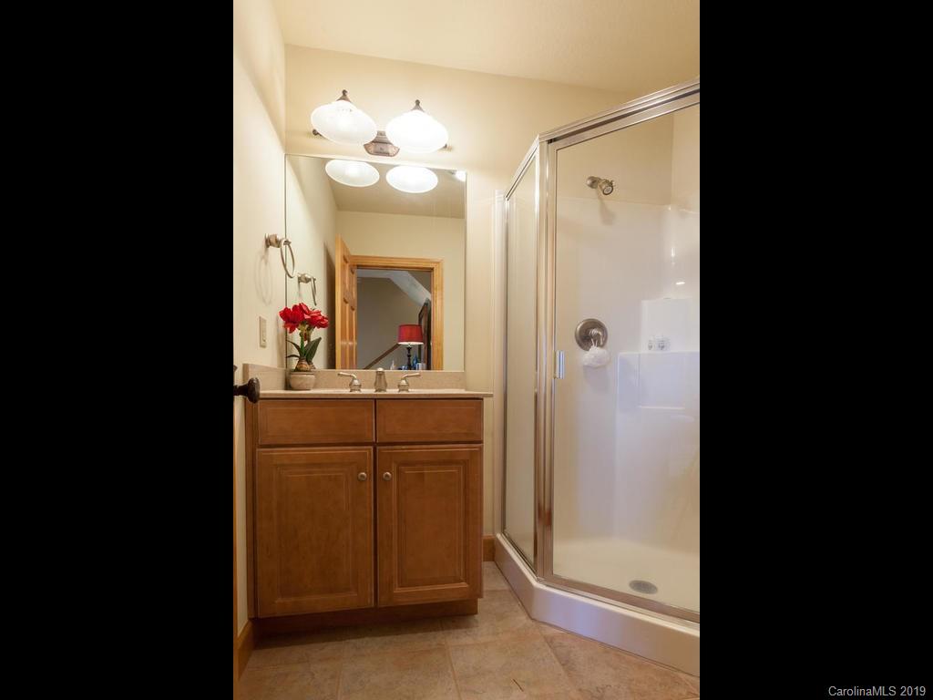 755 Andrew Banks Road Burnsville, NC 28714 - Photo 23 of 24 a bathroom with a sink vanity and a mirror