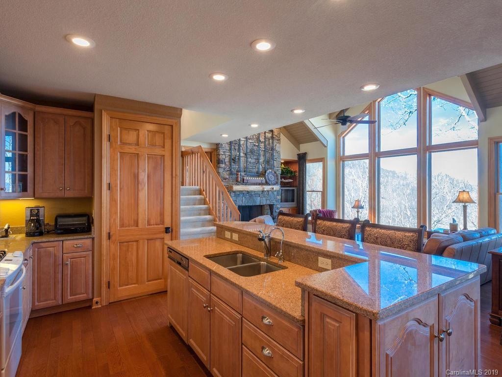 755 Andrew Banks Road Burnsville, NC 28714 - Photo 6 of 24 a kitchen with sink refrigerator and large window