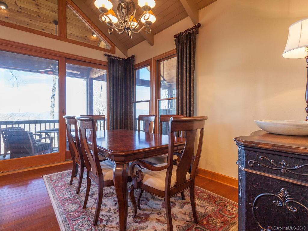 755 Andrew Banks Road Burnsville, NC 28714 - Photo 8 of 24 a view of a dining room with furniture window and wooden floor