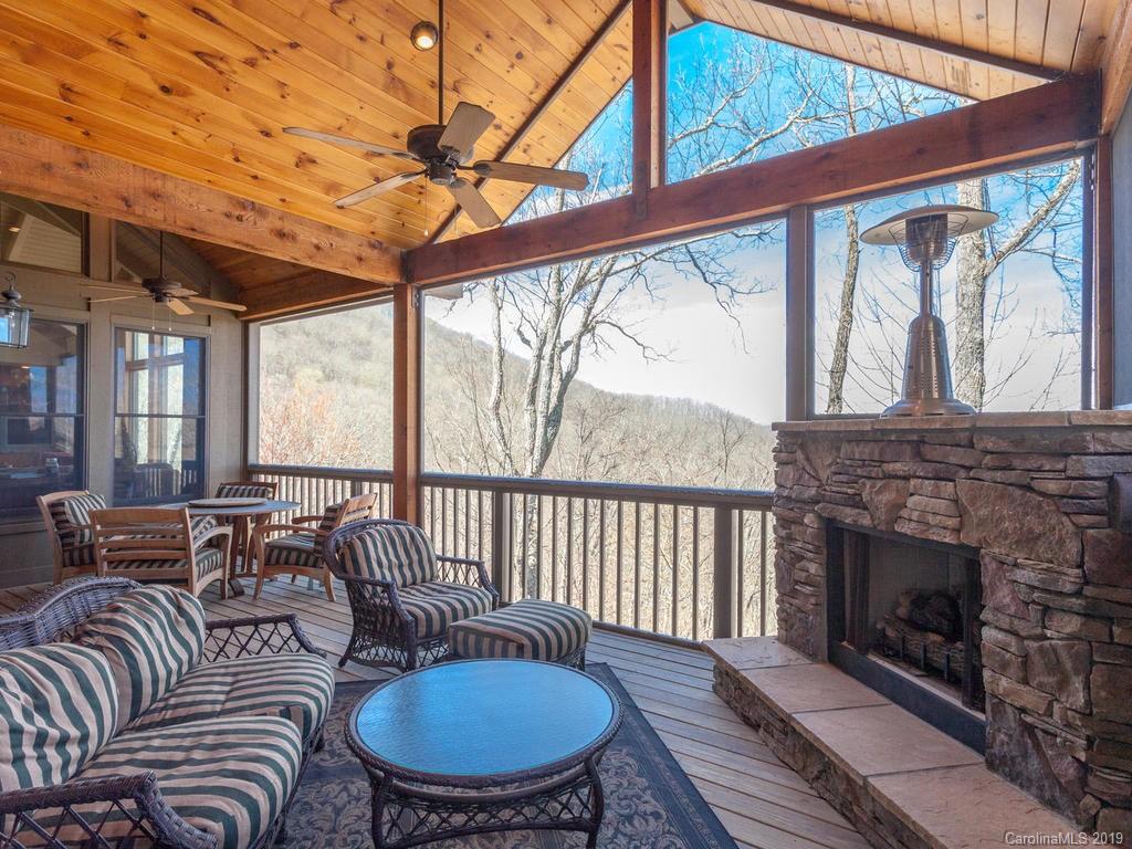 755 Andrew Banks Road Burnsville, NC 28714 - Photo 10 of 24 a living room with furniture a fireplace and a table