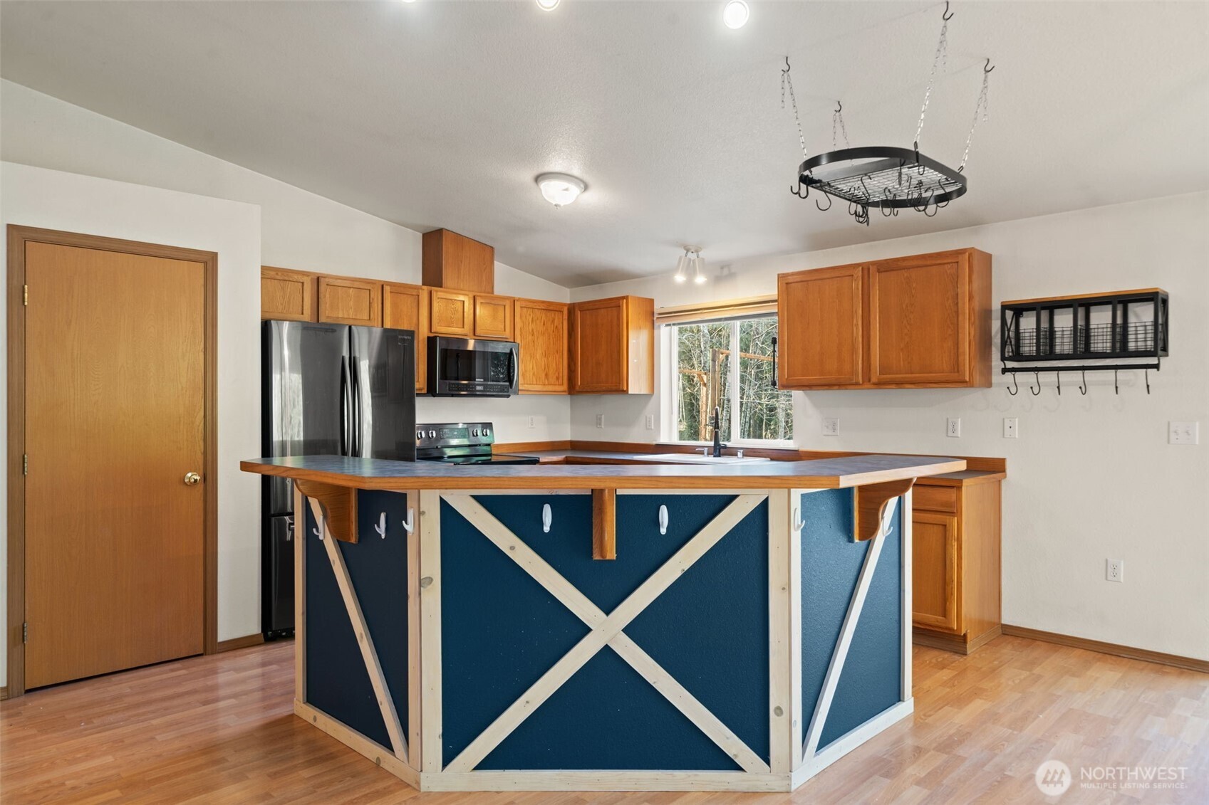 297 Lewis Road West Seabeck, WA 98380 - Photo 11 of 35 a kitchen with stainless steel appliances granite countertop a stove and a refrigerator