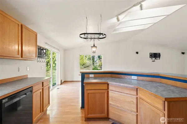 a kitchen with a sink cabinets and window