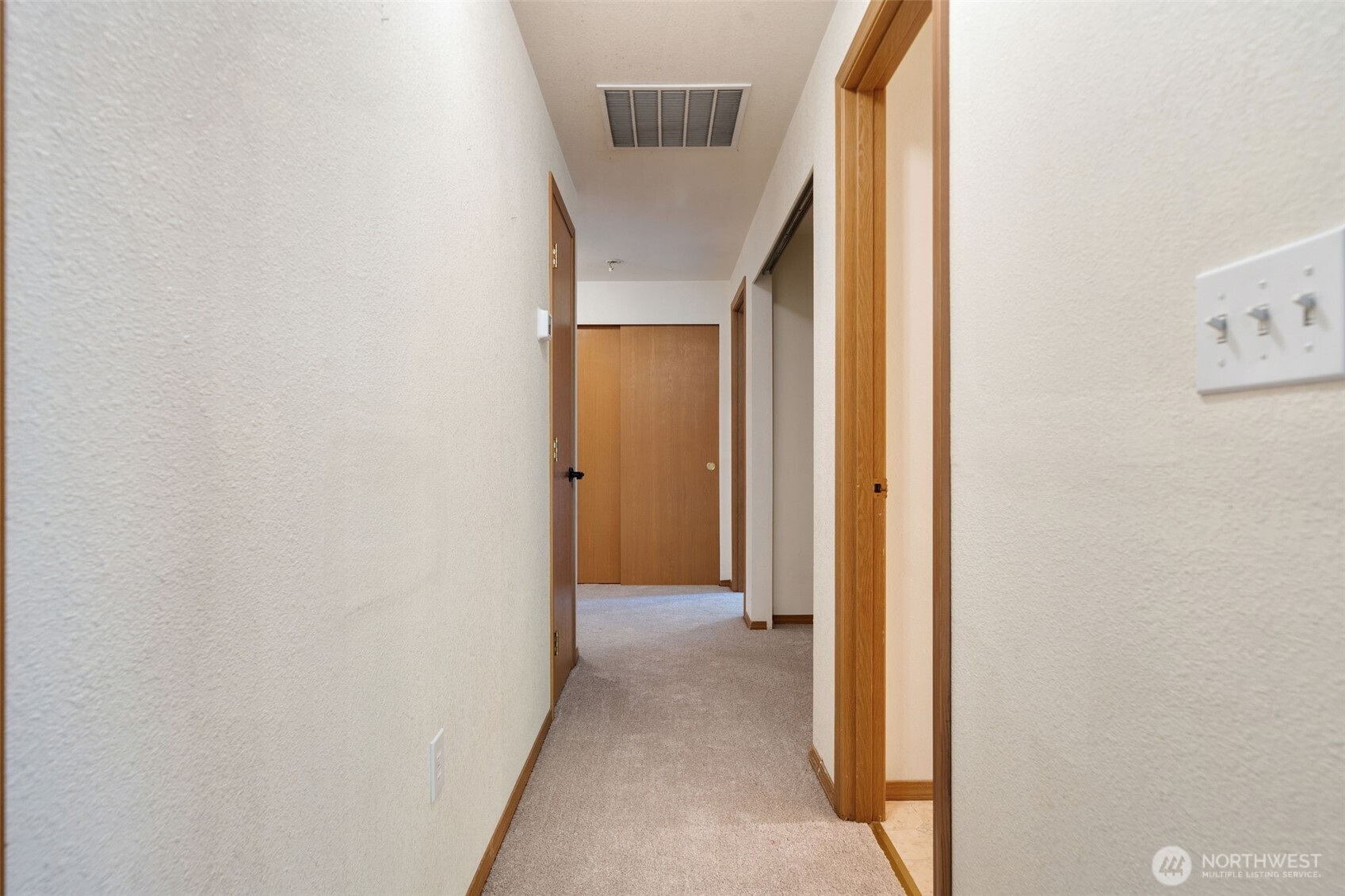 297 Lewis Road West Seabeck, WA 98380 - Photo 17 of 35 a view of a hallway with wooden floor
