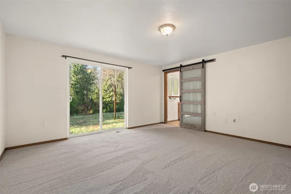 an empty room with closet and mirrors