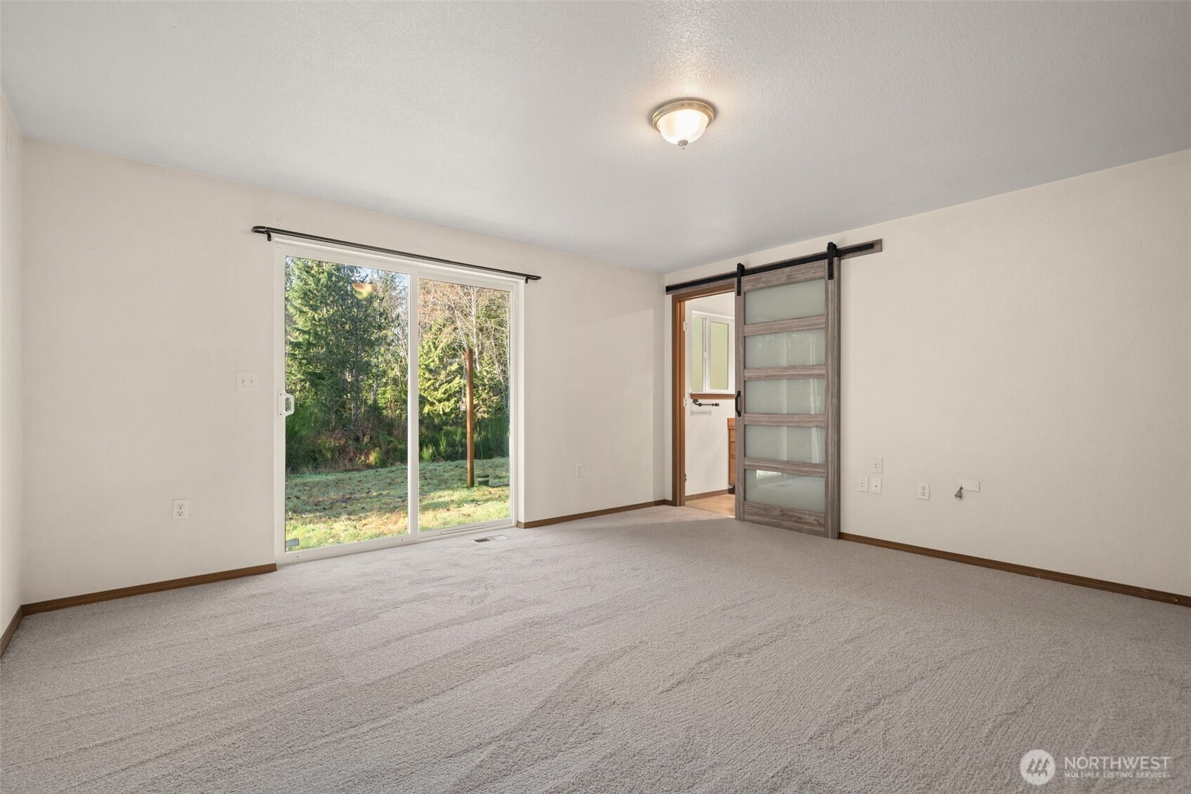 297 Lewis Road West Seabeck, WA 98380 - Photo 23 of 35 an empty room with yard and outdoor view