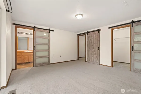 a bathroom with a granite countertop sink toilet a mirror and shower