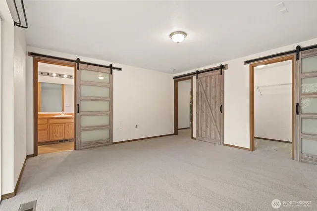 a bathroom with a granite countertop sink toilet a mirror and shower