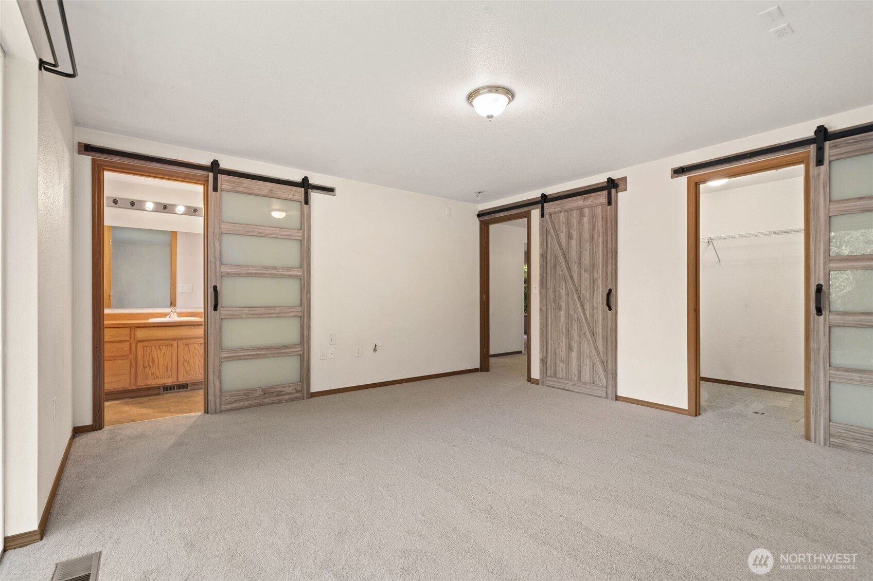297 Lewis Road West Seabeck, WA 98380 - Photo 24 of 35 an empty room with closet and mirrors