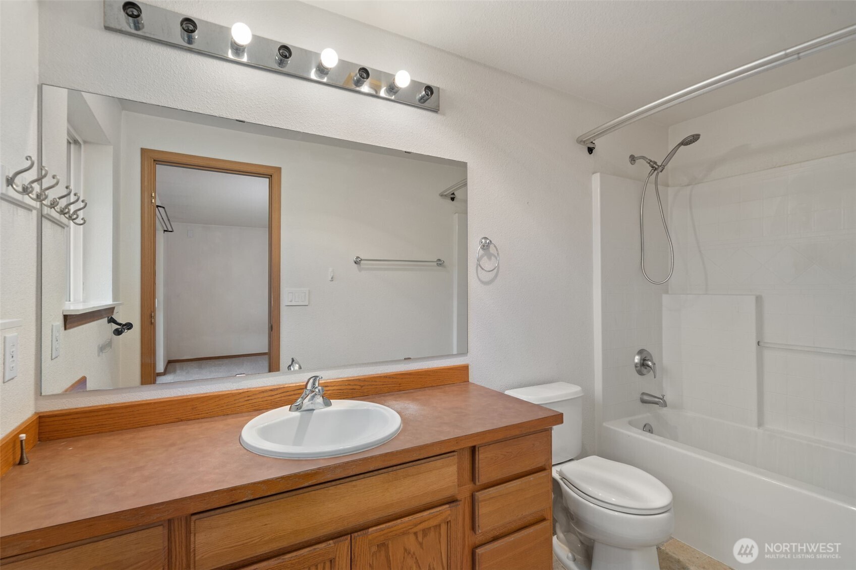297 Lewis Road West Seabeck, WA 98380 - Photo 25 of 35 a bathroom with a granite countertop sink toilet a mirror and shower