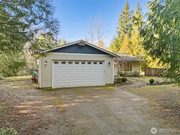 a backyard of a house with a tree and fence