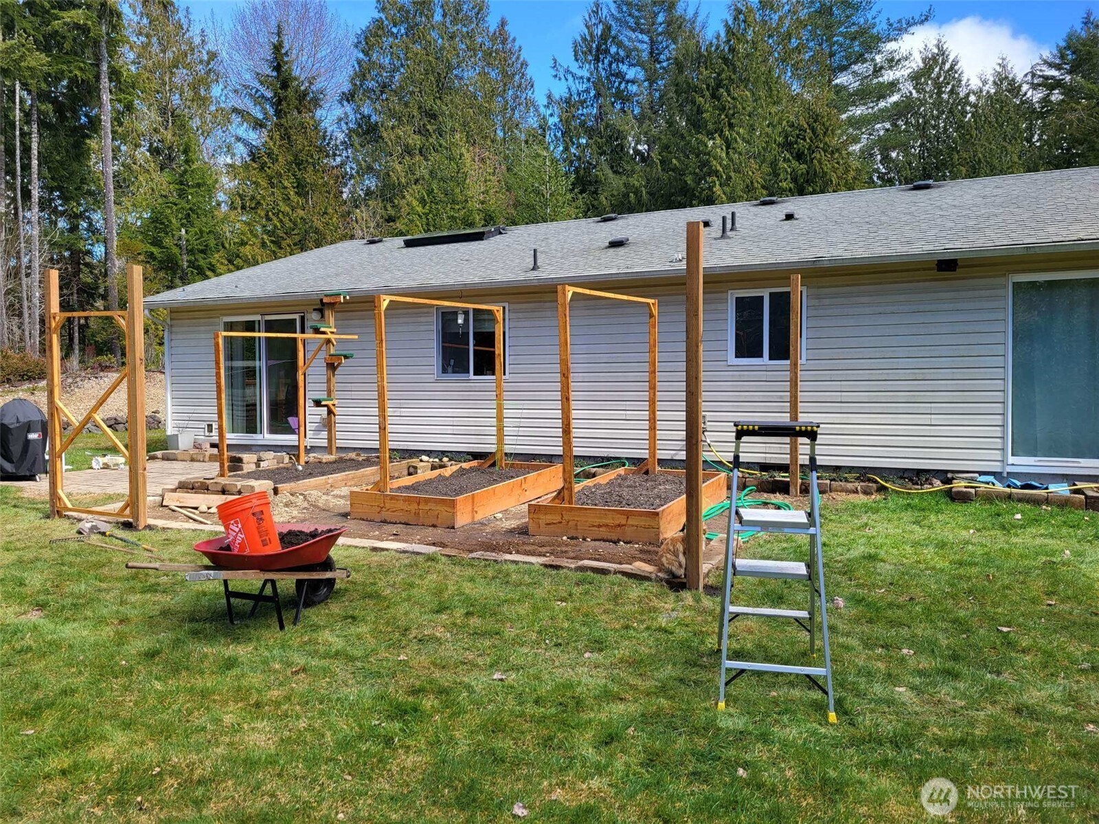 297 Lewis Road West Seabeck, WA 98380 - Photo 33 of 35 a backyard of a house with table and chairs