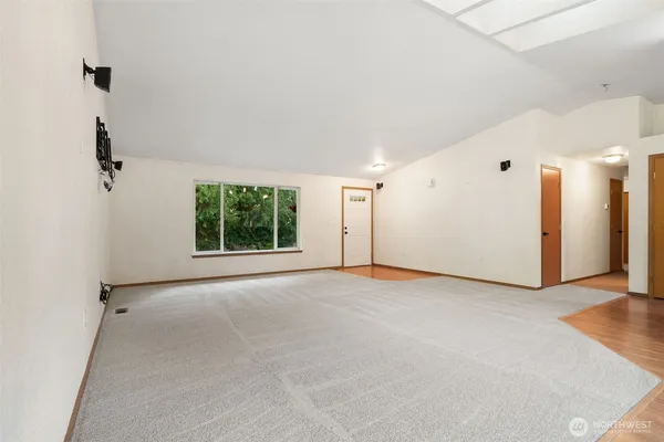 an empty room with windows and closet