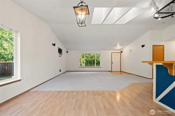 an empty room with windows and closet