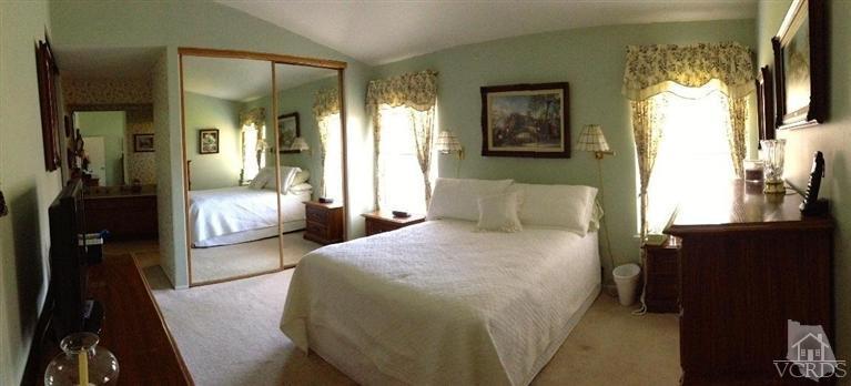 4368 Laurelhurst Road Moorpark, CA 93021 - Photo 13 of 28 a bedroom with a bed and a chandelier