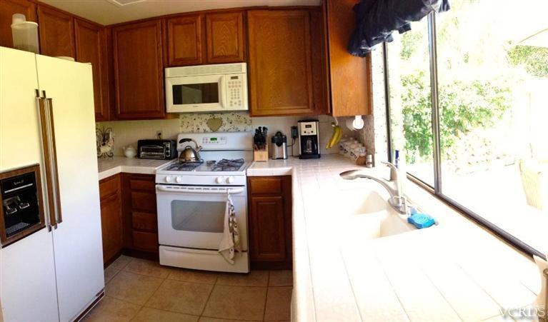4368 Laurelhurst Road Moorpark, CA 93021 - Photo 8 of 28 a kitchen with a sink a stove and a microwave