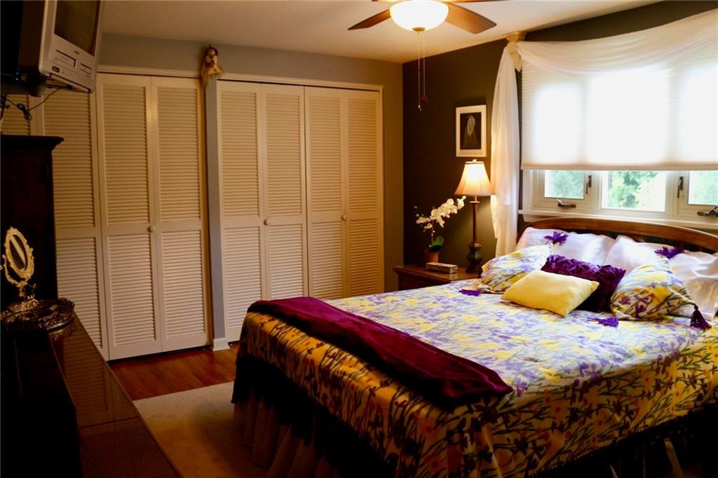 241 McKinney Road Wexford, PA 15090 - Photo 11 of 25 Comfy Master Bedroom with gray walls, large window, 2 sets of bi-fold closets doors, ceiling light & fan, + a linen closet