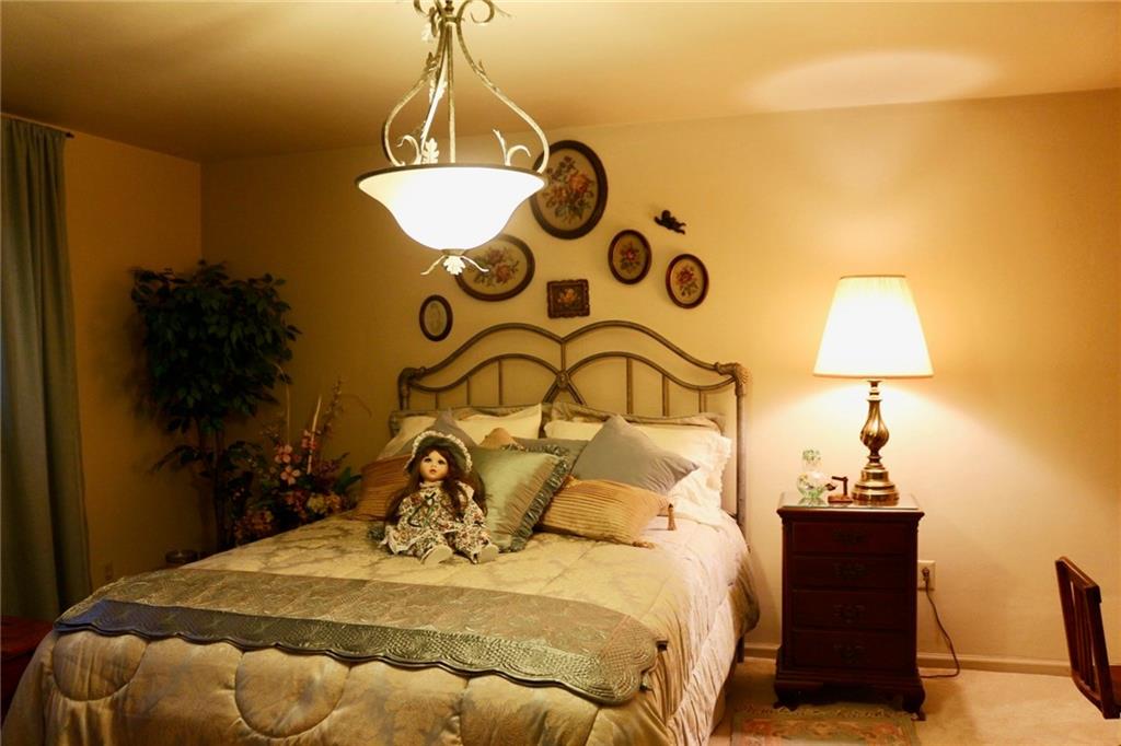 241 McKinney Road Wexford, PA 15090 - Photo 15 of 25 Inviting Guest Bedroom, decorative chandelier, neutral wall to wall carpet & walls.