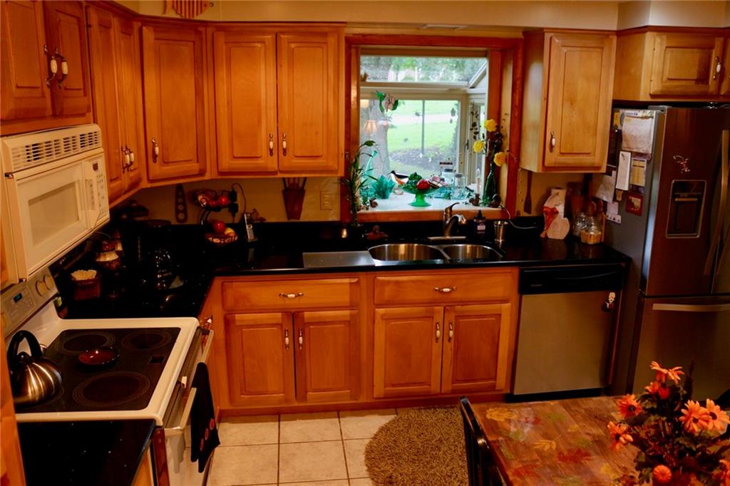 241 McKinney Road Wexford, PA 15090 - Photo 8 of 25 Eat in Kitchen with hickory wood cabinets, black siltstone counter tops, garden window. granite counter top on pony wall, ceramic tile floors
