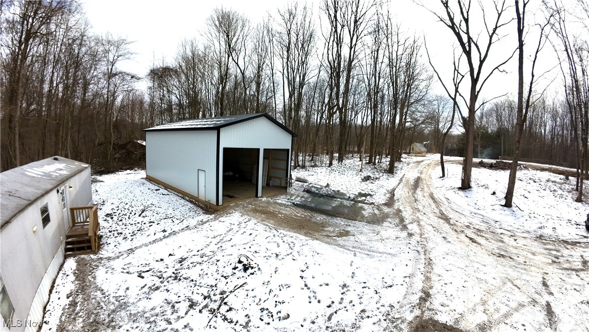 29311 Rabbit Ridge Road Howard, OH 43028 - Photo 33 of 39 Yard covered in snow with an outdoor structure