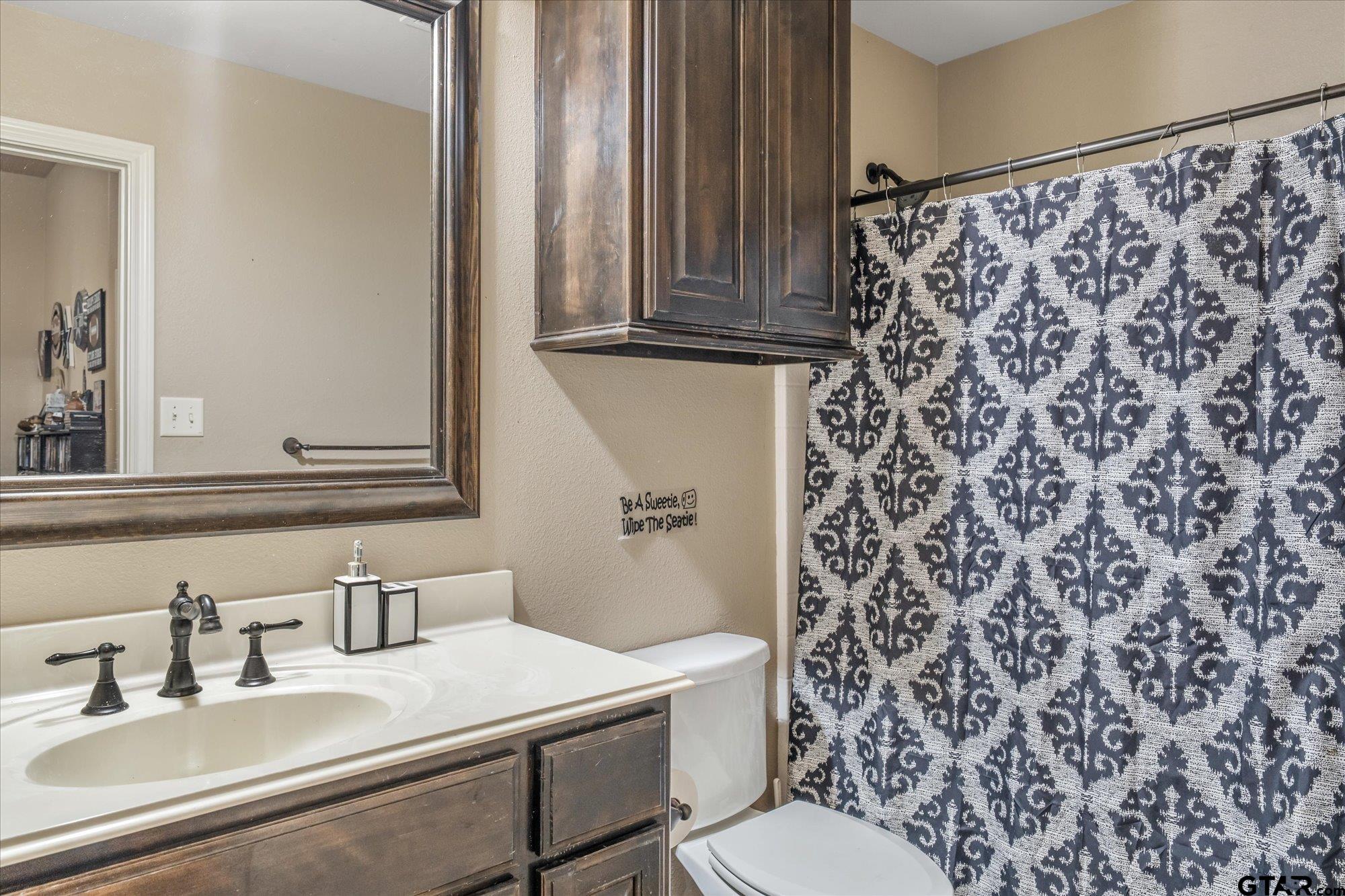 469 Cherokee Street Rusk, TX 75785 - Photo 14 of 35 a bathroom with a sink toilet and mirror