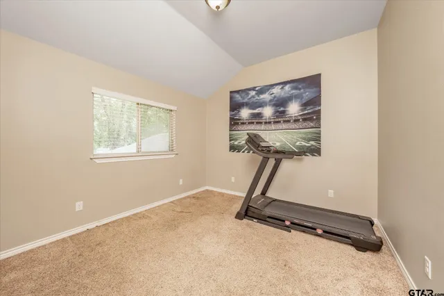 a room with gym equipment and windows