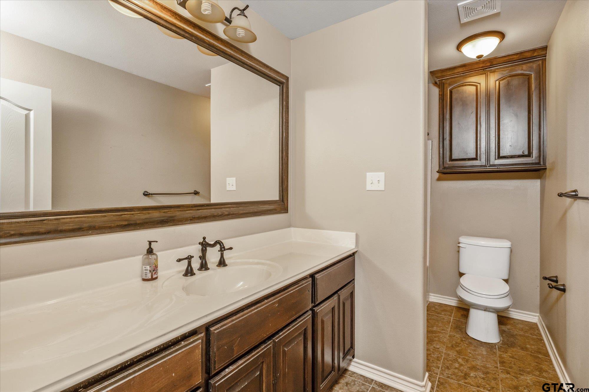 469 Cherokee Street Rusk, TX 75785 - Photo 19 of 35 a bathroom with a sink a toilet and mirror