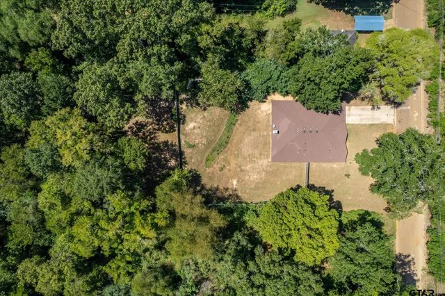 an aerial view of a house with a yard and garden