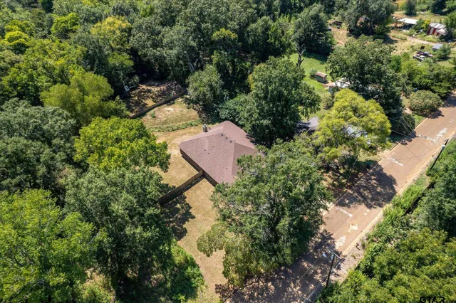 an aerial view of a house with a yard and garden