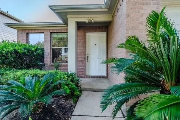 a front view of house and yard with green space