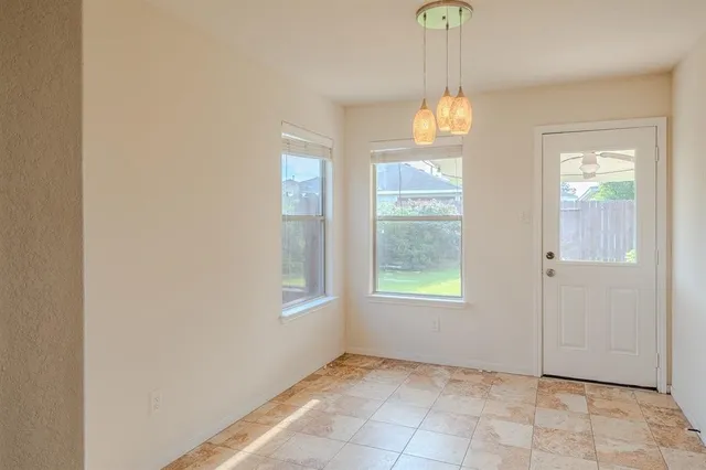 an empty room with windows and entrance