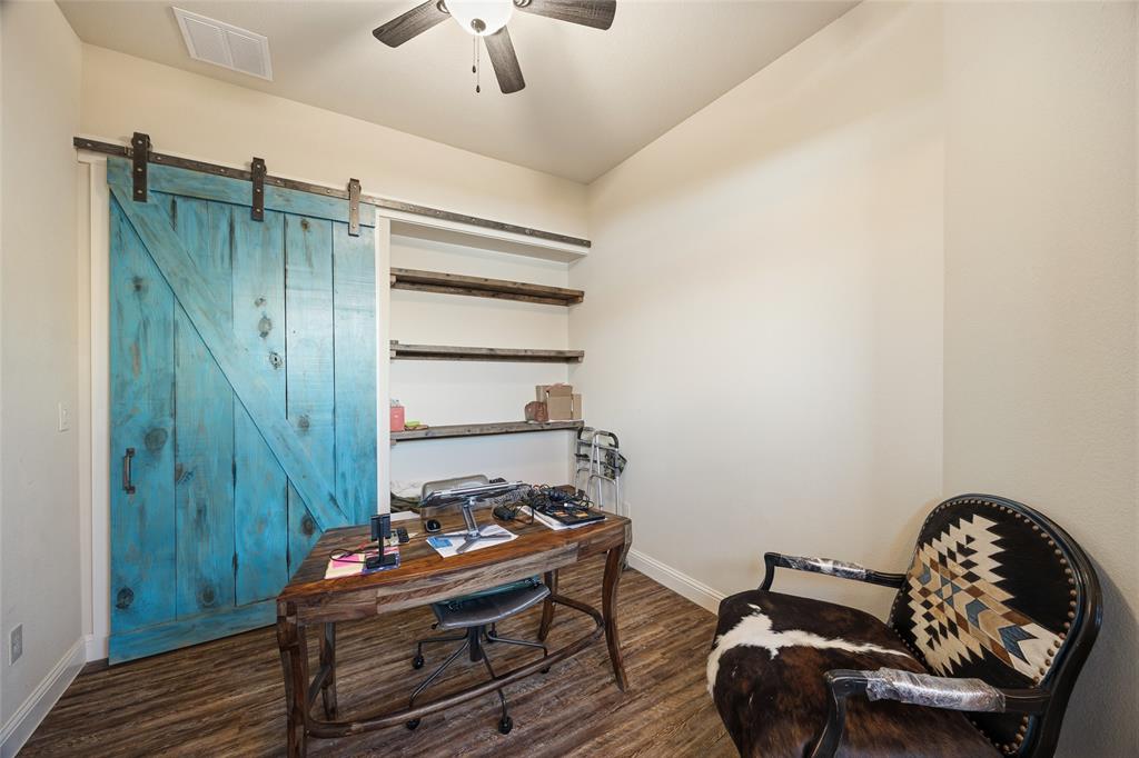 3105 Pastor Street Dallas, TX 75212 - Photo 4 of 28 Home office featuring a barn door, a ceiling fan, and Luxury Vinyl wood like floors