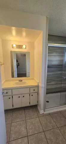 a bathroom with a vanity and mirror