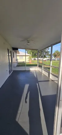 a view of an empty room with large windows