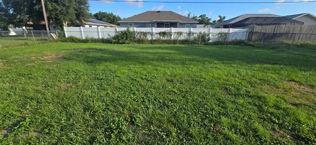 a view of a garden with a house in the background
