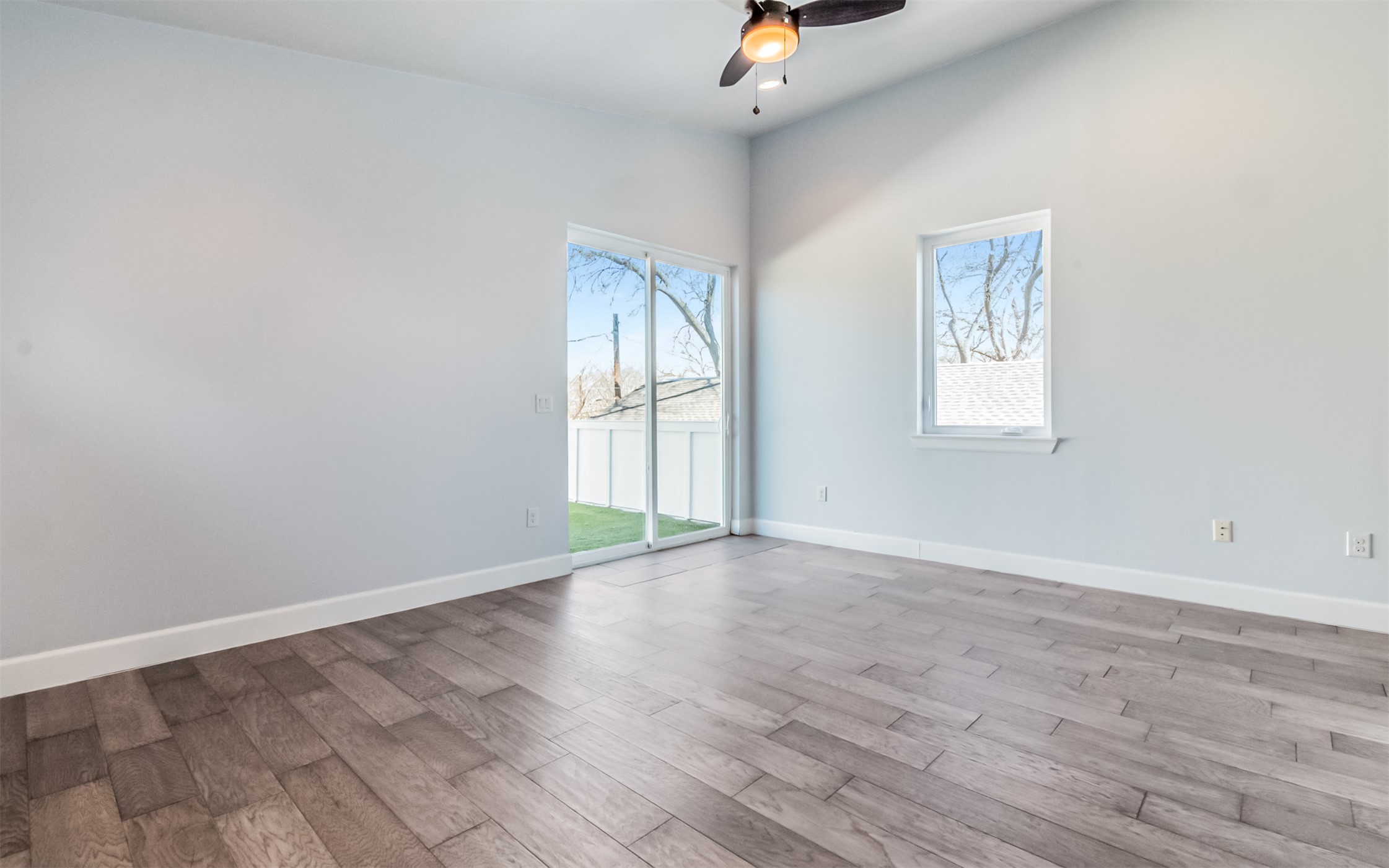 1130 Spur Street, Unit A Austin, TX 78721 - Photo 11 of 31 Unfurnished Primary Bedroom with access to the terrace, recessed lighting, and ceiling fan